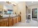 Well-lit bathroom with a long vanity, shower, and access to a walk-in closet at 24422 E Frost Dr, Aurora, CO 80016