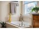Close-up of a built-in bathtub with tile surround and fixtures, filled with decorations at 24422 E Frost Dr, Aurora, CO 80016