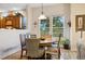 Cozy eat-in kitchen area featuring a round wood table with an assortment of chairs at 24422 E Frost Dr, Aurora, CO 80016