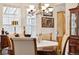 Traditional dining room featuring a dark wood table, upholstered chairs, and an elegant chandelier at 24422 E Frost Dr, Aurora, CO 80016