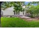 Charming home exterior with stone accents, lush lawn, and mature trees creating a picturesque setting at 24422 E Frost Dr, Aurora, CO 80016