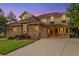 Charming two-story home featuring stone accents, a manicured lawn, and a welcoming porch at 24422 E Frost Dr, Aurora, CO 80016