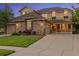 Charming two-story home featuring stone accents, a manicured lawn, and a welcoming porch at 24422 E Frost Dr, Aurora, CO 80016