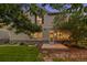 Inviting home exterior featuring stone accents, a green lawn, and mature trees under a twilight sky at 24422 E Frost Dr, Aurora, CO 80016