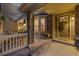 Inviting covered porch featuring a decorative door, stone accents, and outdoor seating at 24422 E Frost Dr, Aurora, CO 80016