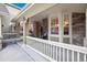Inviting covered porch featuring a decorative door, stone accents, and outdoor seating at 24422 E Frost Dr, Aurora, CO 80016
