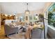 Spacious living area with curved sofas, large windows, and a view into an adjacent kitchen at 24422 E Frost Dr, Aurora, CO 80016