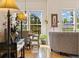 Open-concept living and dining area with hardwood floors, large windows, and ample natural light at 24422 E Frost Dr, Aurora, CO 80016