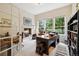 Bright home office featuring a fireplace, large windows with views, and built-in bookshelves at 24422 E Frost Dr, Aurora, CO 80016