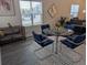 Cozy dining area featuring a glass table with four blue chairs and a patterned rug at 6761 Meade Cir, Westminster, CO 80030