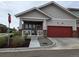 Charming exterior with a red garage door, covered porch and well maintained landscaping at 6761 Meade Cir, Westminster, CO 80030