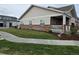 Exterior shot showcasing the well-manicured lawn and walkway leading to the covered porch at 6761 Meade Cir, Westminster, CO 80030