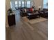 Inviting living room with hardwood floors, a comfortable leather sofa set, and plenty of natural light at 6761 Meade Cir, Westminster, CO 80030