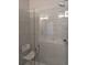 Modern shower with glass doors, rainfall showerhead, and tiled walls at 6761 Meade Cir, Westminster, CO 80030