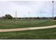 Community baseball field with manicured green grass and convenient walkway at 1920 S Hannibal St # B, Aurora, CO 80013