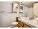 Bathroom featuring white sink and toilet, vanity mirror and medicine cabinets, with a tiled shower at 1920 S Hannibal St # B, Aurora, CO 80013