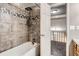 Modern bathroom featuring a shower-over-tub with tiled walls, overhead shower head and hand shower fixture at 1920 S Hannibal St # B, Aurora, CO 80013