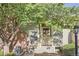 Charming covered front porch with painted railings and view of brick exterior at 1920 S Hannibal St # B, Aurora, CO 80013