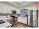 Efficient kitchen with stainless steel appliances, white cabinets, and wood-look flooring at 1920 S Hannibal St # B, Aurora, CO 80013