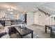 Open-concept living room with seamless flow to the kitchen and staircase at 1920 S Hannibal St # B, Aurora, CO 80013