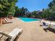 Outdoor swimming pool with lounge seating and surrounding landscaping on a sunny day at 1920 S Hannibal St # B, Aurora, CO 80013