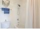 Bathroom featuring a white tiled shower and tub combination with eucalyptus decor for a fresh, clean aesthetic at 2673 Live Oak Ct, Castle Rock, CO 80104