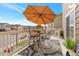Charming deck with an umbrella, outdoor rug, and a cozy dining setup; perfect for relaxing at 2673 Live Oak Ct, Castle Rock, CO 80104