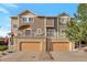 Townhome with attached garages, second-story balconies and neutral exterior color scheme at 2673 Live Oak Ct, Castle Rock, CO 80104