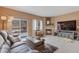 Cozy living room with a fireplace, sliding glass doors, and comfortable seating at 2673 Live Oak Ct, Castle Rock, CO 80104