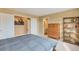 Comfortable main bedroom featuring a sunset picture, dresser, open shelving, and ensuite bathroom with a neutral color palette at 2673 Live Oak Ct, Castle Rock, CO 80104
