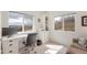 Bright home office space with large windows, built-in shelving, and ample desk space at 2673 Live Oak Ct, Castle Rock, CO 80104