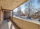 Balcony with textured ceiling and view of neighborhood street with parked cars and surrounding houses at 1366 Garfield St # 209, Denver, CO 80206