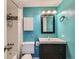 Bathroom with turquoise walls, tile shower and tub combo, updated fixtures, and sleek black vanity at 1366 Garfield St # 209, Denver, CO 80206