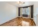 Bedroom featuring hardwood floors, a window with blinds, and stylish two-tone wall paint at 1366 Garfield St # 209, Denver, CO 80206