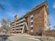 Apartment building with brick exterior, balconies, and street view, providing an urban living experience at 1366 Garfield St # 209, Denver, CO 80206