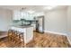 Modern kitchen featuring white cabinetry, stainless steel appliances, and stylish countertop seating at 1366 Garfield St # 209, Denver, CO 80206