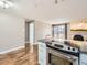 Open-concept kitchen featuring stainless steel appliances and a kitchen island with seating at 1366 Garfield St # 209, Denver, CO 80206