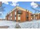 Apartment building featuring brick facade, balconies, and well-maintained landscaping at 3623 S Sheridan Blvd # T6, Denver, CO 80235