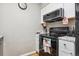 Bright kitchen with white cabinetry, modern appliances, and hard surface floors, perfect for cooking at 3623 S Sheridan Blvd # T6, Denver, CO 80235