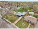 An aerial shot showcases a charming property with a large driveway amidst a lush, established neighborhood with mature trees at 7780 Osceola St, Westminster, CO 80030