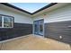 Concrete back patio featuring blue double doors and gray-and-white siding at 7780 Osceola St, Westminster, CO 80030