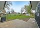 Sprawling backyard with lush lawn, mature trees, and a distant view of the storage garage at 7780 Osceola St, Westminster, CO 80030