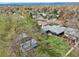 Aerial view showcases home with a large backyard, mature trees, storage shed, and full fencing for privacy at 7780 Osceola St, Westminster, CO 80030