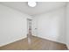 Bedroom with hardwood floors and white walls featuring a door and light fixture at 7780 Osceola St, Westminster, CO 80030