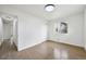 Bedroom featuring hardwood floors, white walls and trim, closet with sliding doors, a window, and hallway at 7780 Osceola St, Westminster, CO 80030