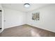 Bright bedroom showcasing a window with view, hardwood floors, and white walls and trim at 7780 Osceola St, Westminster, CO 80030