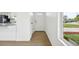 Bright entryway with refinished hardwood floors and open layout that transitions to the kitchen at 7780 Osceola St, Westminster, CO 80030