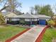 Well maintained home featuring gray and white siding, landscaped front yard, and blue garage door at 7780 Osceola St, Westminster, CO 80030