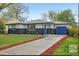 This single Gathering home features a well maintained lawn, garden beds, and matching blue garage and entry doors at 7780 Osceola St, Westminster, CO 80030