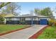Charming home with a blue door and garage in front of a beautiful lawn and inviting driveway at 7780 Osceola St, Westminster, CO 80030